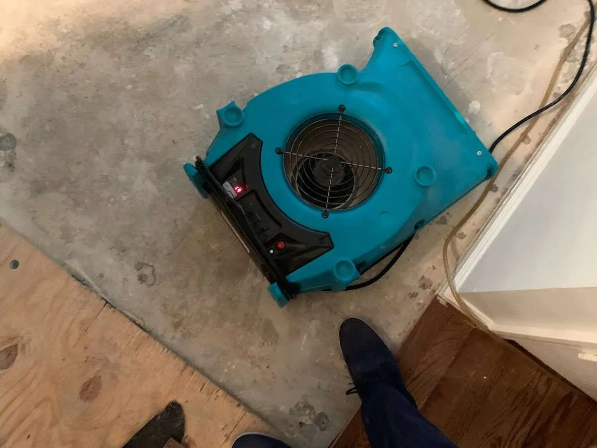 Air mover drying subfloor during Leak Detection & Repair in Merrimack